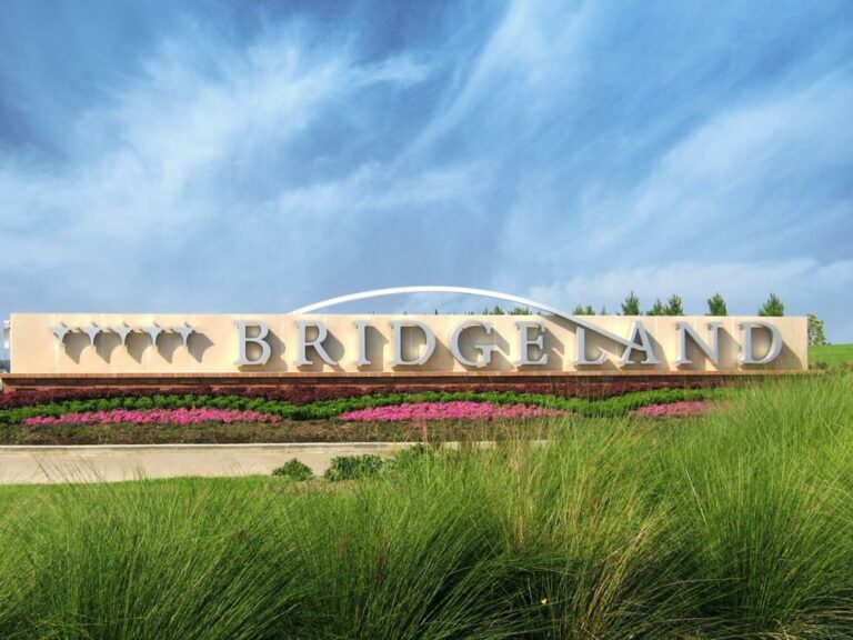 Bridgeland Project Entrance Sign with green foliage in the foreground