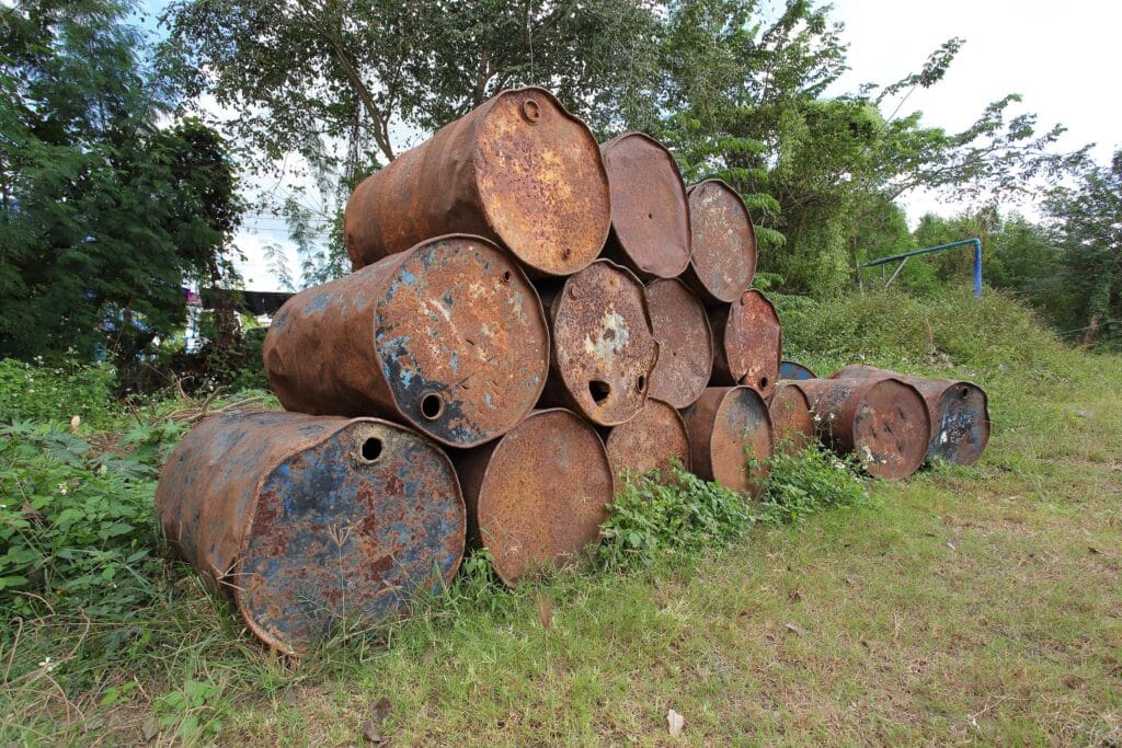 old rusty metal fuel tanks stacked in a row